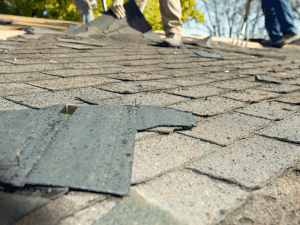 Roofing contractors removing old shingles from a roof in Peachtree City, GA.