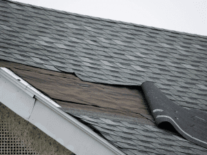Partially installed shingles and exposed underlayment on a roof in Fayetteville, GA.
