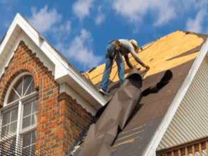 Roofer applying underlayment to a roof in Peachtree City, GA