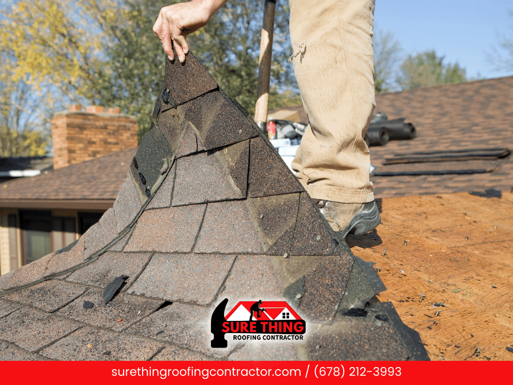 Roofer replacing damaged shingles on a roof in Peachtree City, GA